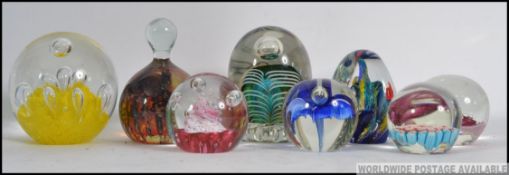 A collection of 20th century glass paperweights & dumps to include a Caithness Tango,