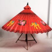 An early 20th century large decorative Japanese parasol with red ground and decorated with birds