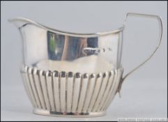 A Victorian silver hallmarked cream jug / creamer by Stokes & Ireland bearing marks for Birmingham
