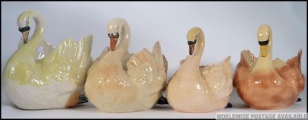 A collection of 4 large ceramic swan planters.