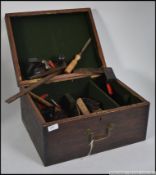 A vintage wooden 20th century tool box with lift up lid revealing a small quantity of wood working