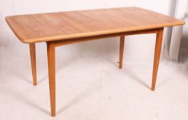A 20th century good quality ash refectory retro dining table raised on turned and tapered legs with