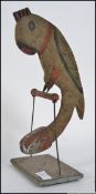 A vintage 20th century wooden hand painted parrot balance figure pendulum. Measures: 34cm H.