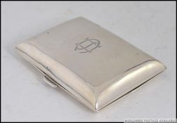 A silver hallmarked cigarette case with central monogram.