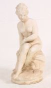 A 20th century reconstituted stone figure of a semi clad maiden / lady in a classical pose,