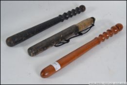 3 20th century police truncheons, one being polished wood, the other ebonised and 1 x plain.