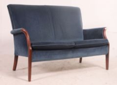 A retro Parker Knoll teak show wood framed sofa of smaller proportions,