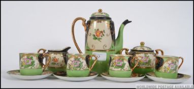 A vintage 20th century Japanese porcelain 4 place tea service complete with the teapot in an