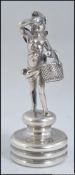 A 19th century.silver hallmarked bottle cork top with winged cherub and basket adornment.