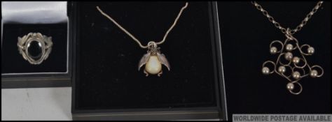 Three pieces of silver ( stamped 925 ) jewellery to include two pendant necklaces one pendant being