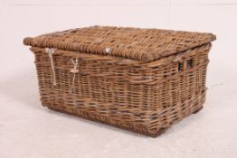 A good early 20th century thick whicker laundry / basket chest having hinged top.