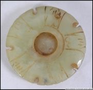 An unusual Chinese carved Jade rounded having incised details with pierced edgings.