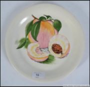 A hand painted Sunkissed Royal Staffordshire Dinnerware plate by Clarice Cliff,