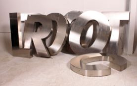 A collection of eight industrial large aluminum letters,