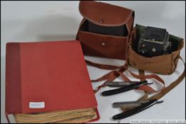 A collection of items to include 2 box brownies, a Reflecta camera, 2 German cut throat razors,