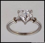 An 18ct white gold ring with large prong set heart cut moissanite. Size K.5. Weight 3.5g.