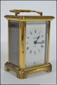 A brass carriage clock with an 8 day movement made by Bayard Of Paris.