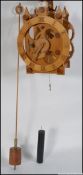 A vintage wooden skeleton wall clock complete with pendulum , weights , etc Measures: 44cm L.