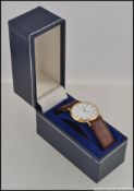A 20th century Mappin & Webb gold plated watch on leather strap complete in the case.