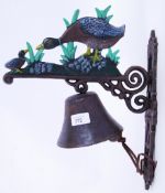 A cast iron 20th century hand painted wall decor exterior bell, with duck decoration to top.