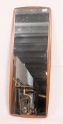 A large 1970's retro frameless teak wall mirror of atomic form.