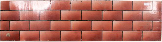 A vintage enamel metal advertising sign with brickwork design, the metal of rectangular form.