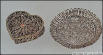 A silver metal filigree lidded heart shaped pot along with another filigree silver metal ( tested