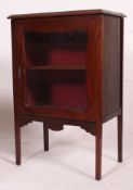 An Edwardian inlaid mahogany music / display cabinet enclosed by single glazed door,