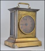 A brass musical carriage clock, having a chase decorated panel,