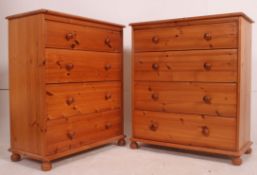 A pair of 20th century antique style pine chests of drawers being raised on bun feet with straight