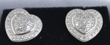 A good pair of silver and cz adorned heart shaped ear studs complete in the presentation box