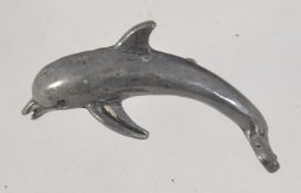 A vintage figuaral pewter brooch pin in the form of a dolphin with roller clasp. Measures 4.5cms.