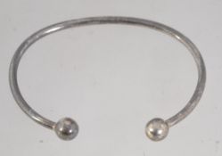 A 925 silver cuff bangle bracelet with ball finial decoration. Marked 925. Weight 9.6g.