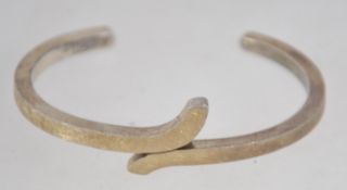 A heavy 925 silver cuff bangle bracelet with wrap over design with textured decoration. Marked 925.