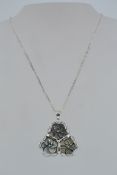 A 925 silver pendant necklace with large abalone carved flowers in a silver setting strung on a