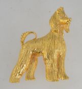 A vintage gold tone figural brooch in the form of an Afghan Hound dog with rhinestone eyes and