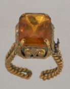 A early 20th century yellow metal Czech faceted glass ring with rope twist shank. Size R expanding.
