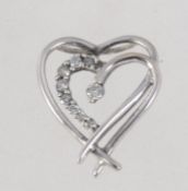 A 9ct white gold and diamond pendant in a heart form with channel set diamonds approx 10pts .