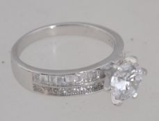 A silver ladies contemporary dress ring having single cz round cut claw mounted stone to centre.