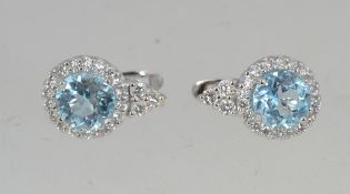 A pair of 925 silver earrings set with an aquamarine style stone and halo CZ in a tear drop shape