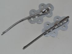 A pair of white metal 1930s Art Deco paste set hair grip pins with clear paste stones set in a