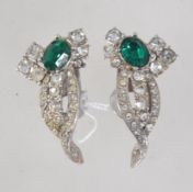A pair of vintage rhinestone set white metal clip on earrings set with a vivid emerald green and