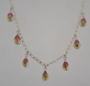 A 925 silver droplet necklace with lucite and silver encased dried roses roses.