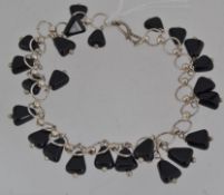 A vintage white metal and French jet drop bracelet with hook clasp. Measures 7.5inches.