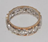 A vintage hallmarked two colour 9ct gold full eternity band ring with inset clear stones and