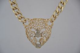 A vintage chunky yellow metal curb chain necklace with large rhinestone encrusted cat panther and