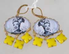 A pair of vintage drop earrings with yellow glass dangle with centrl pictorial cabochon of Carmen