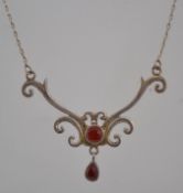 A 925 silver pendant necklace set with in a celtic design with carnelian drop cabochons.