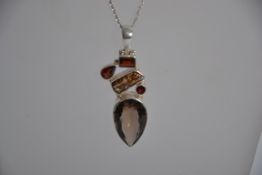 A large Sterling silver, smokey quartz, garnet & baroque pearl pendant on chain. Both marked 925.