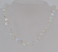 A vintage faceted round AB crystal glass bead necklace with a paste set clip clasp.
